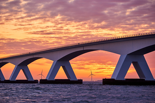 Zeeland Bridge, The Netherland during a beautiful sunrise. The Zeelandbrug (build 1965) is a traffic bridge over the Oosterschelde with a total length of 5022 meters.