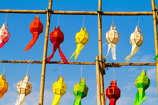 Hanging thai paper lanterns in clear sky at bamboo grid for festival in Lampang