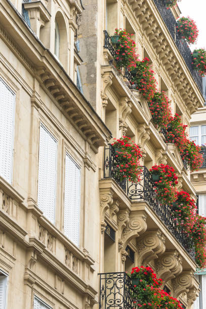 istock Beautiful parisian building decorated by red flowers; 2050805712