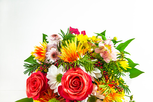 Bouquet of red roses and various flowers on a white background;