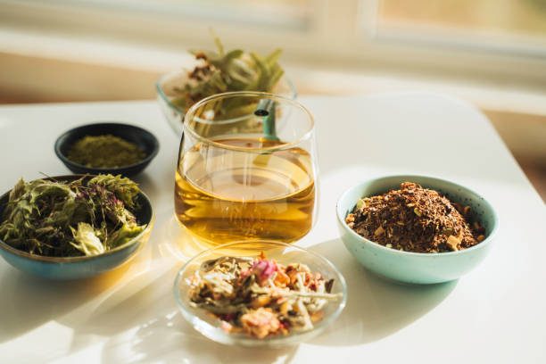 istock A cup of tea with dry fruit, flowers, and herbs. 2050813200