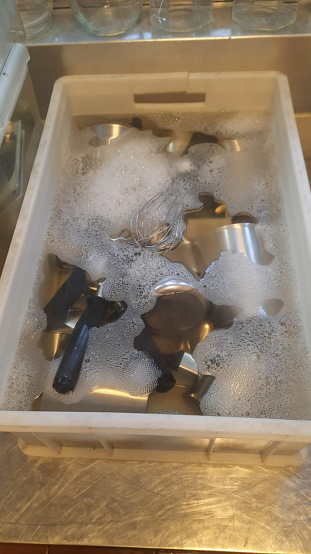 The utensils kept in the water and soap view in the dishwasher