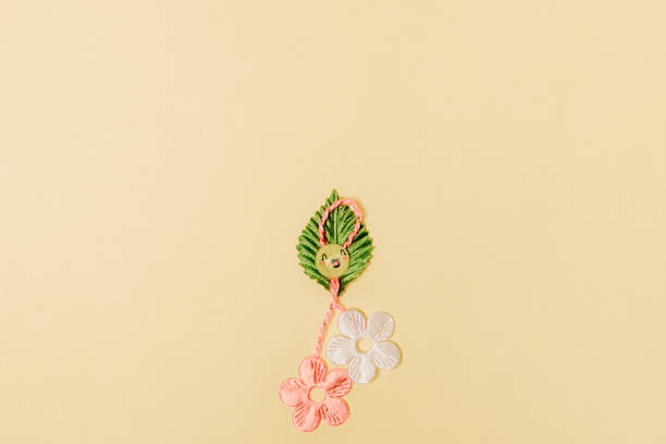 istock One beautiful floral martisor on a soft yellow background. 2050850782