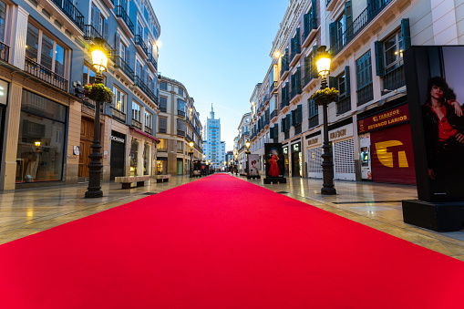 Malaga, Andalusia, Spain - March 1, 2024. Málaga prepares for the annual film festival crowds of movie stars, fans and photographers with a red carpet walk, walkway. The film festival, Festival de Málaga features Spanish language films and offers movie screening throughout the city and an award ceremony. The film industry crews, fans and celebrities flock to the Costa del Sol city for the citywide celebration. It is one of many European film festivals but it is also one of the best.