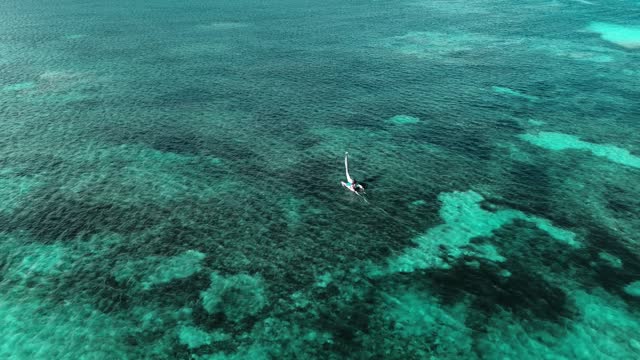 Drone footage aerial top view of catamaran sailing in open sea. Caribbean Sea
