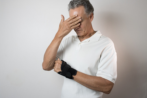 Man wearing a brace on his wrist for pain management