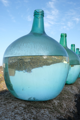Artistic display of glass bottles on an outdoor wall in Lanzarote