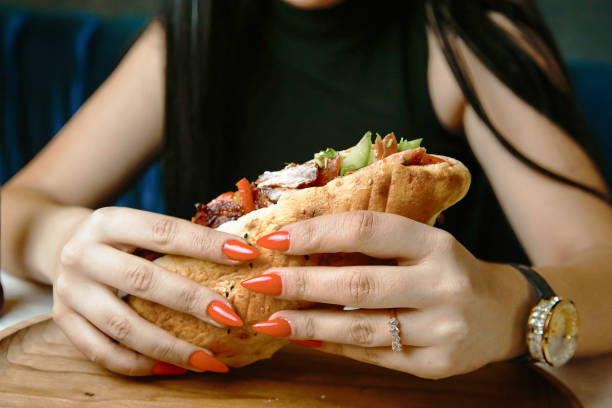 istock Woman Sitting at Table With Sandwich 2050926148