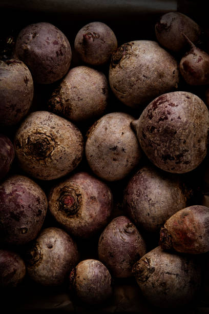 Closeup of a bunch of beets on a dark background