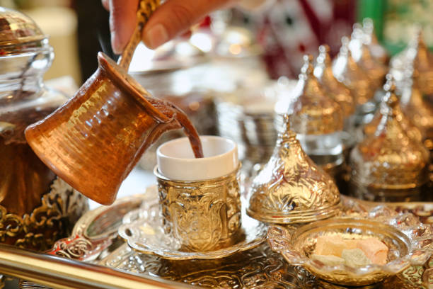istock Person Pouring Tea Into Cup on Tray 2050938477