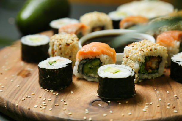istock Wooden Board With Sushi and Cucumbers 2050947343
