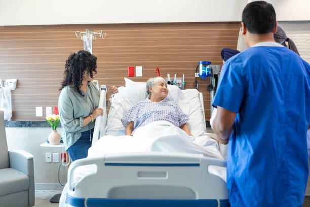 istock Woman stands by bed while mom talks to ER doctors 2050951972