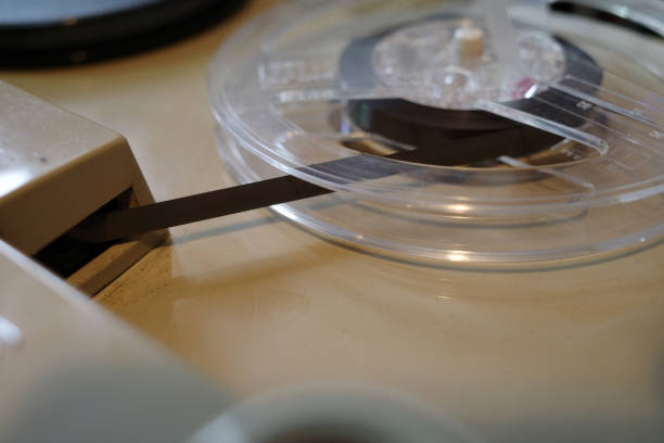 Detail of an vintage tape recorder: a plastic reel with magnetic tape