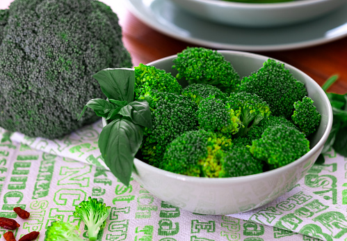 Closeup view of fresh raw green broccoli on the table. Healthy eating,  vegetarian, vegan cuisine. Eat vegetables concept
