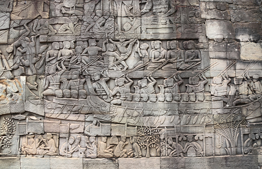 Wall carving of Prasat Bayon Temple in famous landmark Angkor Wat complex, Siem Reap, Cambodia. Bas-relief depicting peasants going about daily routine