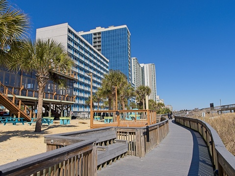 Mid rise condo and vacation rentals along the boardwalk and beach of Myrtle Beach South Carolina.