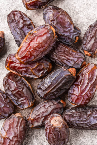 istock Dried delicious date fruit on vintage stone background 2051045898