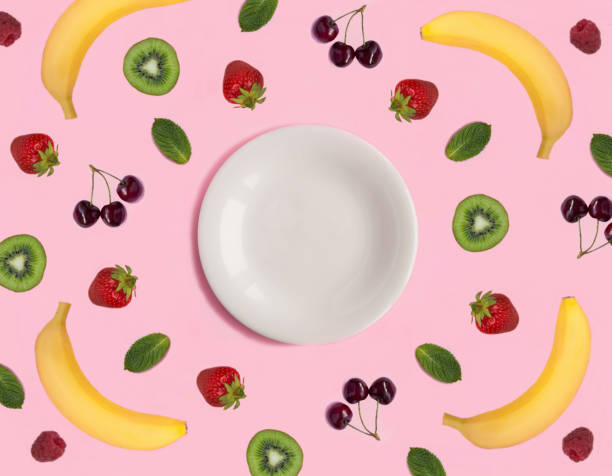 istock Empty white plate for text, fruit and berry on the pink background. Top view. Copy space. 2051052080