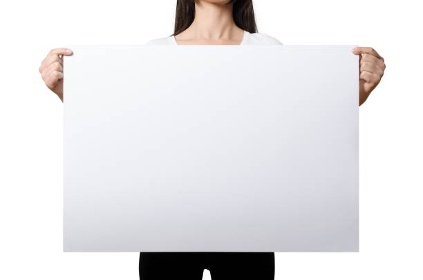istock Close up view female hand hold on white paper board. 2051055731