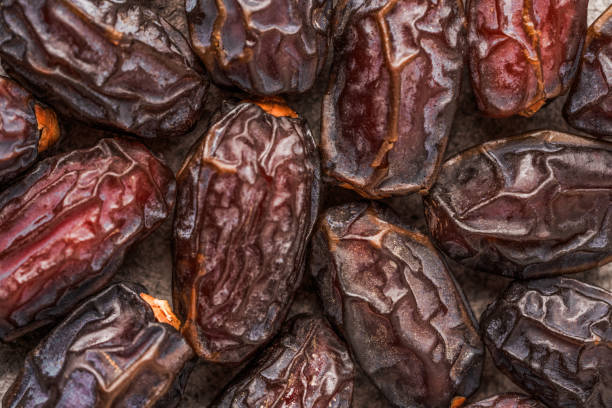 istock Dried delicious date fruit on vintage stone background 2051056784