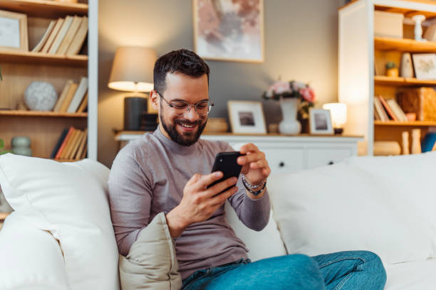 istock Handsome man enjoying in a free time in his home 2051063027