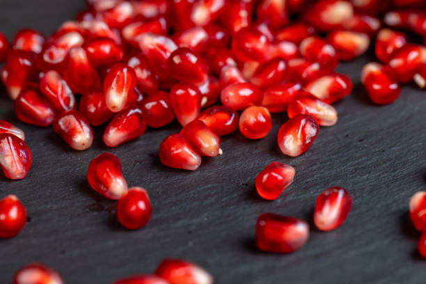 Red ripe pomegranate on the table, sweet red pomegranate close-up