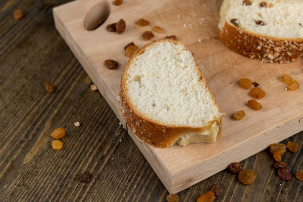 istock sweet bun with golden raisins, closeup 2051073361