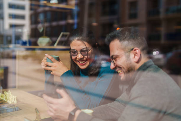 istock Part of a series: Man and woman using mobile phone in a coffee shop for coffee break 2051113336
