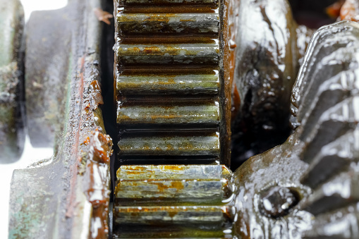 Detail of the transmission mechanism from the crank to the chuck of an old hand drill. Worn grease can be seen on the gears of this unit.