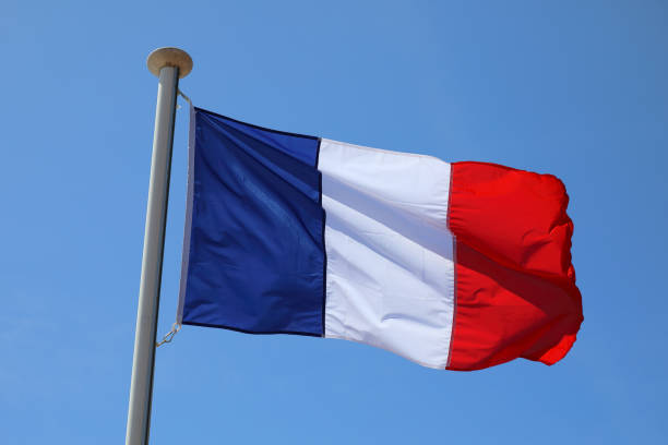 istock French flag waving against blue sky 2051115505