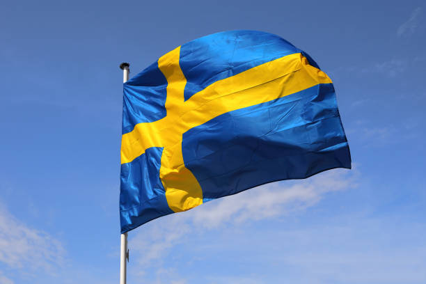 istock Swedish flag flies against blue sky 2051118661