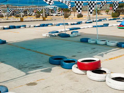 Temporary go-kart track in a supermarket parking lot.  Blue and white tires to demarcate the track
