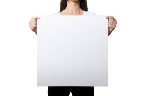 istock Close up view female hand hold on white paper board. 2051132999