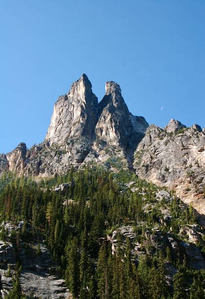 Liberty Bell Mountain As Seen From North Cascade Highway Liberty Bell Mountain with moon as seen from the North Cascades Highway in Washington liberty bell mountain stock pictures, royalty-free photos & images