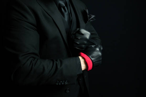 istock Stylish Gangster Pulling on Black Leather Gloves 2051166361