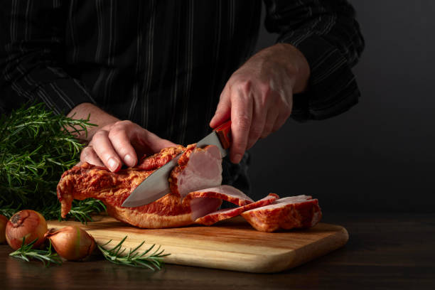istock The cook cuts smoked pork on the kitchen table. 2051202699
