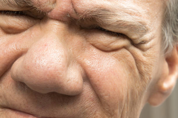 Close up of senior man's blue eyes looking at camera.