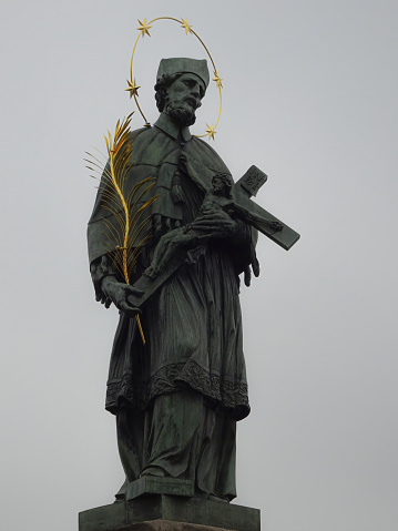 Statue of St. John Nepomuk, the patron saint of Prague, on the Charles Bridge in Prague, Czech Republic