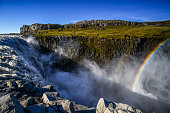 A rainbow on the spray of powerful Dettifoss waterfall