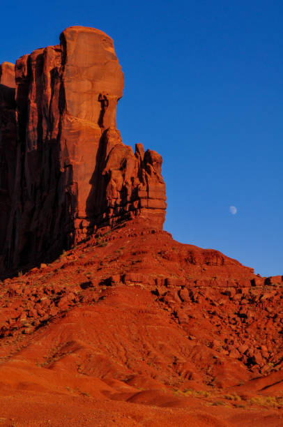 torri di arenaria illuminate dal tramonto e la luna nella monument valley - the western wall foto e immagini stock