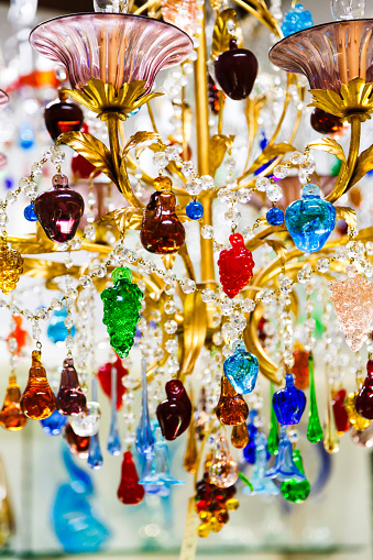 Colorful crystal or glass pendants chandelier or lamp from the world-famous Murano glass. Traditional venetian glass chandelier in branded gift shop, Murano island, Venice, Italy.
