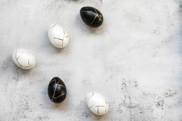 istock Luxury and elegant Easter black and white eggs decorated with gold on concrete background 2051306429