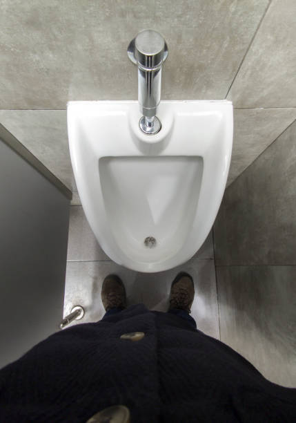 Close-up of a clean, modern toilet bowl as the toilet is flushed.