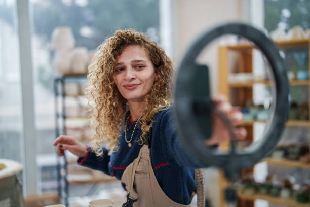 Woman shooting a marketing video about ceramic works.