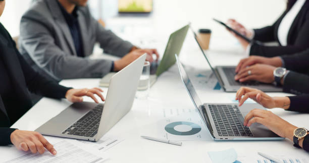 istock Group of business people at meeting in office with laptop, documents and teamwork for web feedback, schedule or agenda. Networking, men and women with computer, online market research and workshop. 2051401837