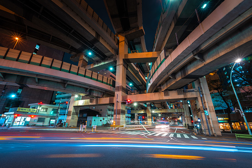 Futuristic highways soaring through neon night city lights Tokyo Japan