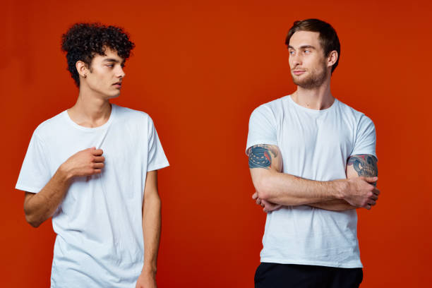 istock men in white t-shirts communication friendship red background 2051449975