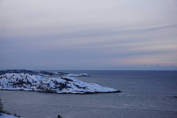 The snow covered isle of Skorpa seen from Kvitnes in Kristiansund, Norway.