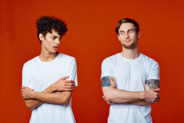 istock two men in white t-shirts on a red background friendship 2051461510