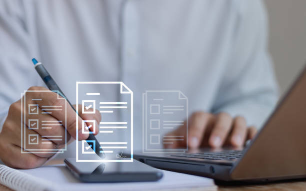 istock E-document management paperless workplace, e-signing, online electronic signature, document management system. Business people sign distance contract agreements with digital pen on mobile phone. 2051476657